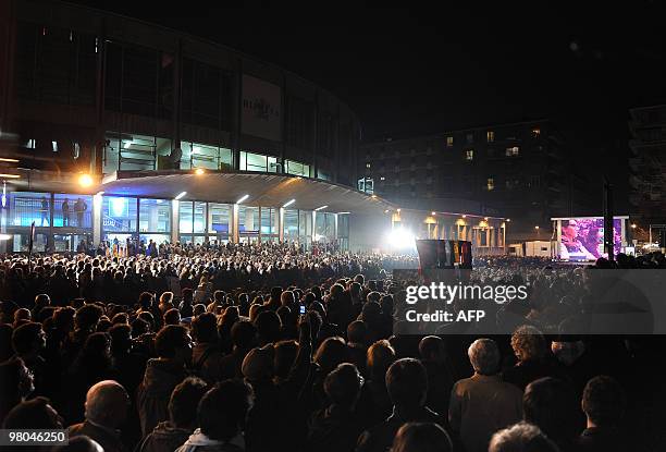 Thousands of people watch a monitor outside Paladozza sport hall televising the talk show "RAI per una notte " of Italian TV host and journalist...
