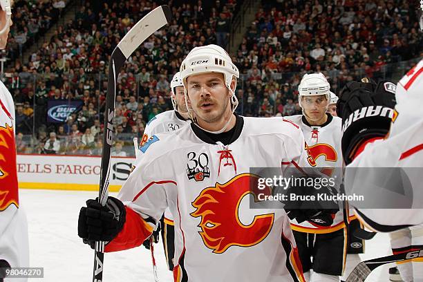 Ian White of the Calgary Flames celebrates after scoring a goal against the Minnesota Wild during the game at the Xcel Energy Center on March 21,...