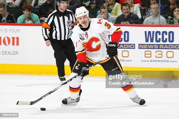 Ian White of the Calgary Flames prepares to shoot the puck against the Minnesota Wild during the game at the Xcel Energy Center on March 21, 2010 in...