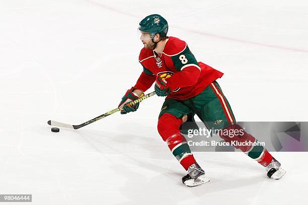 Brent Burns of the Minnesota Wild skates with the puck against the Calgary Flames during the game at the Xcel Energy Center on March 21, 2010 in...