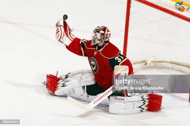 Josh Harding of the Minnesota Wild makes a glove save against the Calgary Flames during the game at the Xcel Energy Center on March 21, 2010 in Saint...