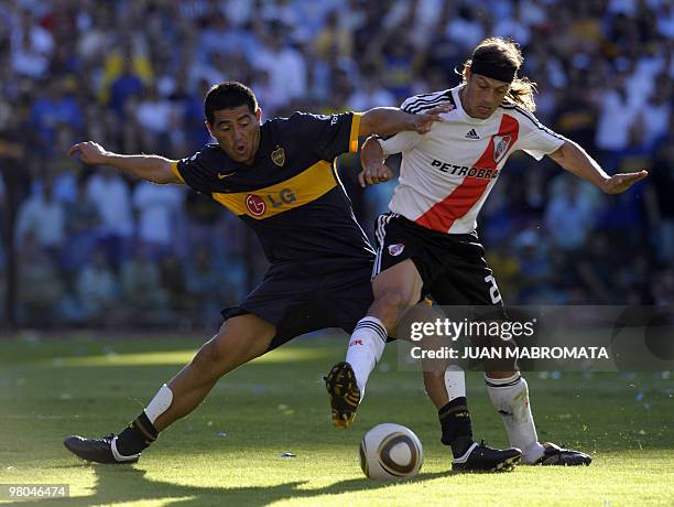 Boca Juniors' midfielder Juan Roman Riquelme vies with River Plate's midfielder Matias Almeyda during an Argentina's first division football match at...