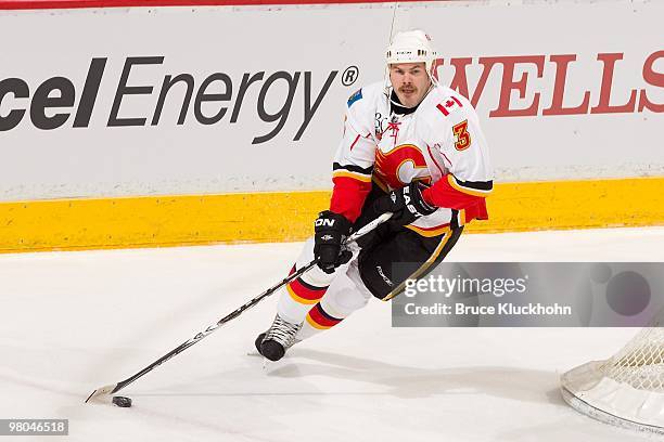 Ian White of the Calgary Flames skates with the puck against the Minnesota Wild during the game at the Xcel Energy Center on March 21, 2010 in Saint...