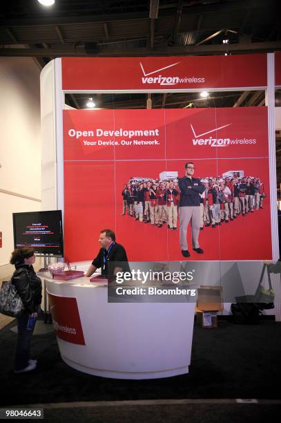 An attendee gets information at the Verizon Communications Inc. Booth at the CTIA Wireless conference in Las Vegas, Nevada, U.S., on Thursday, March...
