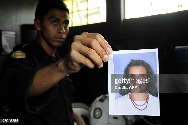 Police officer shows a picture of French national Florence Demefle in San Jose Pinula, 30 km east of Guatemala City, March 25, 2010. Denefle, who was...