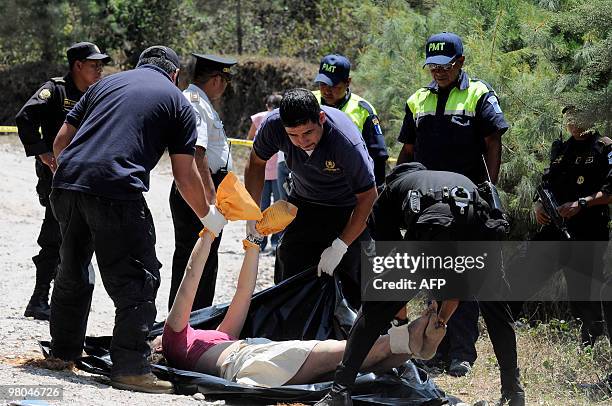 Forensic personnel place on a stretcher the corpse of French national Florence Demefle in San Jose Pinula, 30 km east of Guatemala City, March 25,...