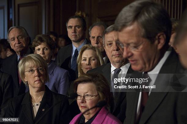 Senate Democrats during a news conference look on as Senate Finance Chairman Max Baucus, D-Mont., speaks during a news conference after the Senate...