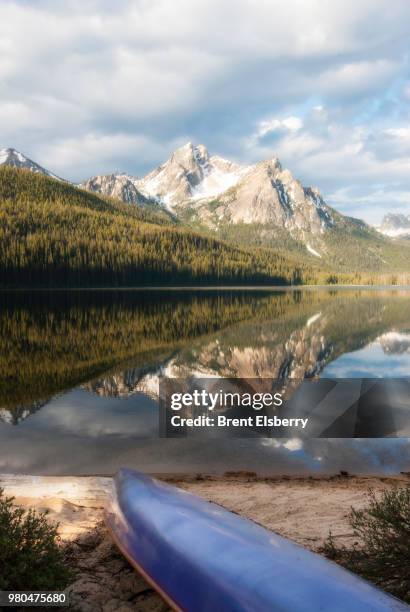 mountains of sawtooth range reflecting in stanley lake and canoe on shore, custer county, idaho, usa - sawtooth national recreation area stock pictures, royalty-free photos & images