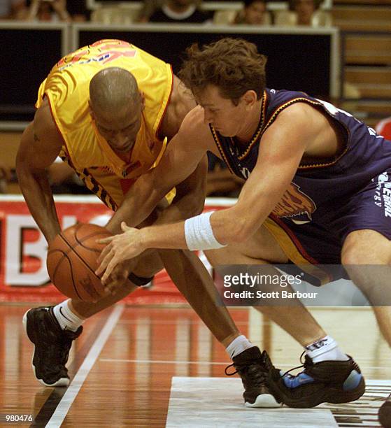 Blair Smith of West Sydney and Clarence Tyson of Melbourne Tigers compete for the ball during the National Basketball League match between the West...