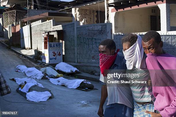 People walk in the streets, past dead bodies on January 14, 2010 in Port au Prince, Haiti. As the world rallies to help, emergency efforts try and...