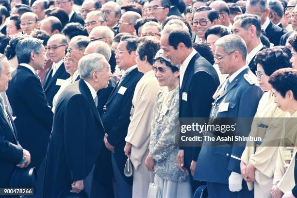 Emperor Hirohito talks with hammer thrower Shigenobu Murofushi during the spring garden party at the Akasaka Imperial Garden on May 20, 1987 in...