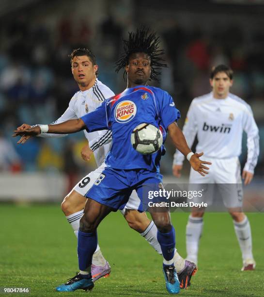 Derek Boateng of Getafe robs the ball from Cristiano Ronaldo of Real Madrid during La Liga match between Getafe and Real Madrid at the Coliseum...
