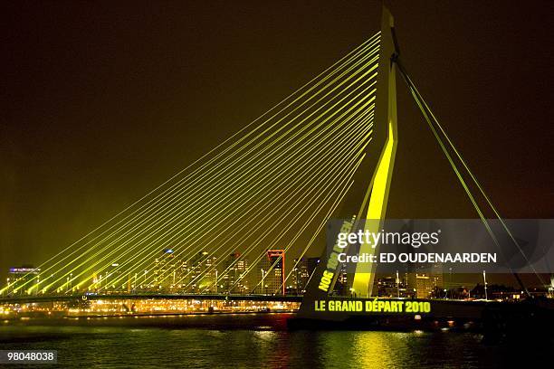 The Erasmus Bridge is bathed in yellow light in Rotterdam on March 25, 2010 to mark the 100 day countdown for the start of the Tour de France cycling...