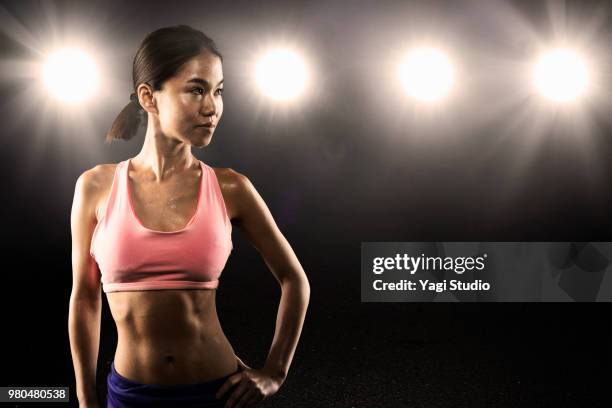 female athlete standing in studio - athlete bulges stock pictures, royalty-free photos & images