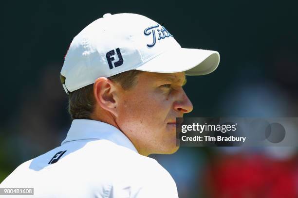 Peter Malnati of the United States stands on the 18th green during the first round of the Travelers Championship at TPC River Highlands on June 21,...