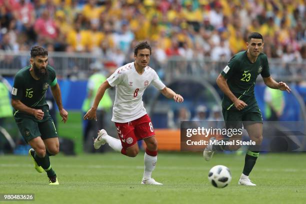 Thomas Delaney of Denmark tracked by Mile Jedinak and Tom Rogic of Australia during the 2018 FIFA World Cup Russia group C match between Denmark and...