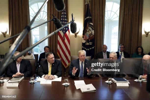 President Donald Trump, center, speaks while Mike Pompeo, U.S. Secretary of state, from second left, James Mattis, US secretary of defense, and...