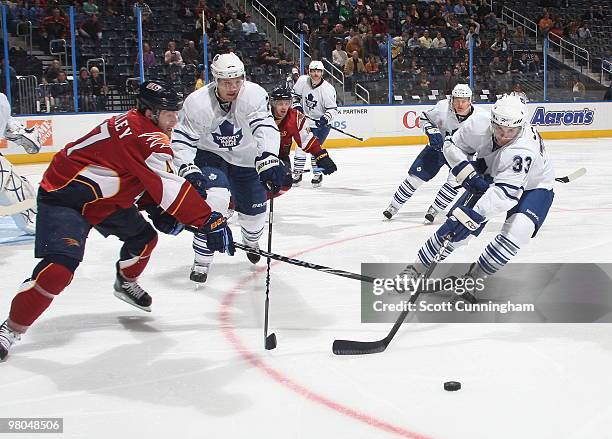 Luca Caputi of the Toronto Maple Leafs battles for the puck against Rich Peverley of the Atlanta Thrashers at Philips Arena on March 25, 2010 in...