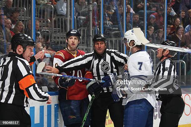 Officials separate Garnet Exelby of the Toronto Maple Leafs from Colby Armstrong of the Atlanta Thrashers at Philips Arena on March 25, 2010 in...