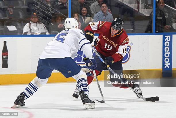 Marty Reasoner of the Atlanta Thrashers fires a shot against Tomas Kaberle of the Toronto Maple Leafs at Philips Arena on March 25, 2010 in Atlanta,...