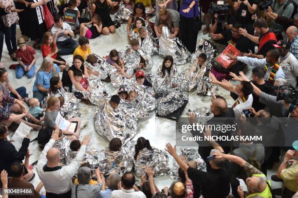 The Franciscan Action Network , Faith in Action and the DMV Congregation Network holds a prayer vigil with children wrapped in survival blankets and...