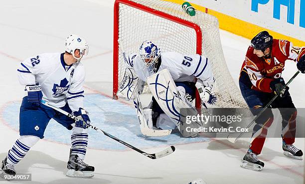 Francois Beauchemin of the Toronto Maple Leafs defends as goaltender Jonas Gustavsson saves a deflected shot by Colby Armstrong of the Atlanta...