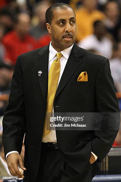 Head coach Lorenzo Romar of the Washington Huskies coaches in the first half against the West Virginia Mountaineers during the east regional...