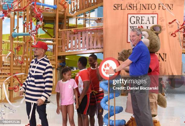 Chance the Rapper and CEO of Great Wolf Resorts Murray Hennessy press button to officially open the Great Wolf Lodge Illinois on June 21, 2018 in...