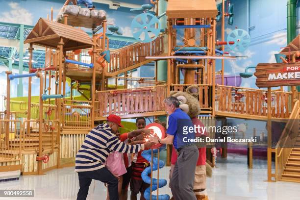 Chance the Rapper and CEO of Great Wolf Resorts Murray Hennessy press button to officially open the Great Wolf Lodge Illinois on June 21, 2018 in...