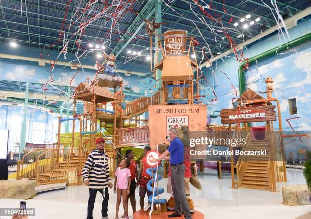 Chance the Rapper and CEO of Great Wolf Resorts Murray Hennessy press button to officially open the Great Wolf Lodge Illinois on June 21, 2018 in...