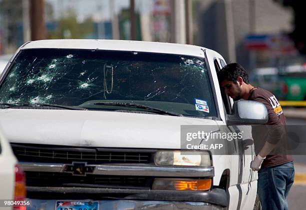 Member of the Mexican police looks into a pick up truck in Ciudad Juarez, on March 25 where two corpses were found. Ciudad Juarez, with 1.3 million...