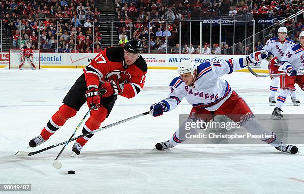 Ilya Kovalchuk of the New Jersey Devils is challenged for possession of the puck by Marc Staal of the New York Rangers during the first period at the...