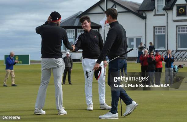 Tom Slowman of Taunton & Pickeridge , is congratulated by Wilco Nienaber of Republic of South Africa and his caddie at the 18th hole after beating...