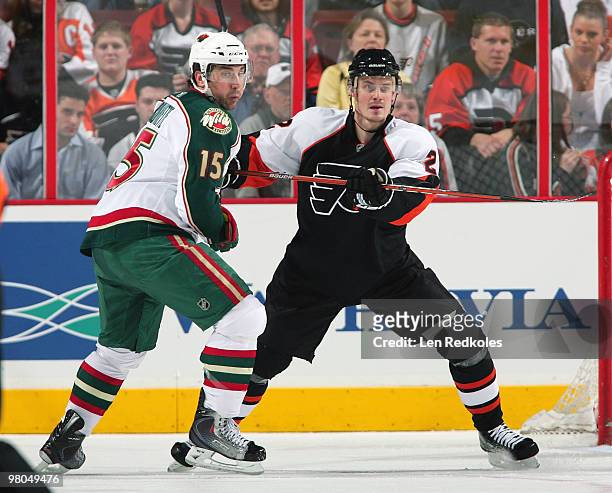 Lukas Krajicek of the Philadelphia Flyers battles for position with Andrew Brunette of the Minnesota Wild on March 25, 2010 at the Wachovia Center in...