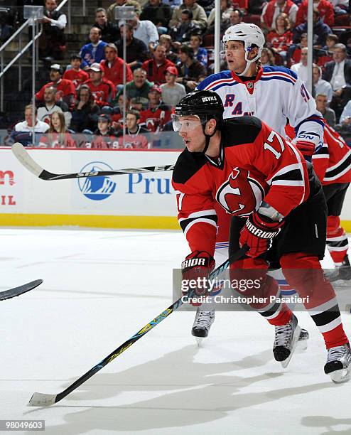 Ilya Kovalchuk of the New Jersey Devils eyes the action down the ice while being defended by Matt Gilroy of the New York Rangers during the game at...