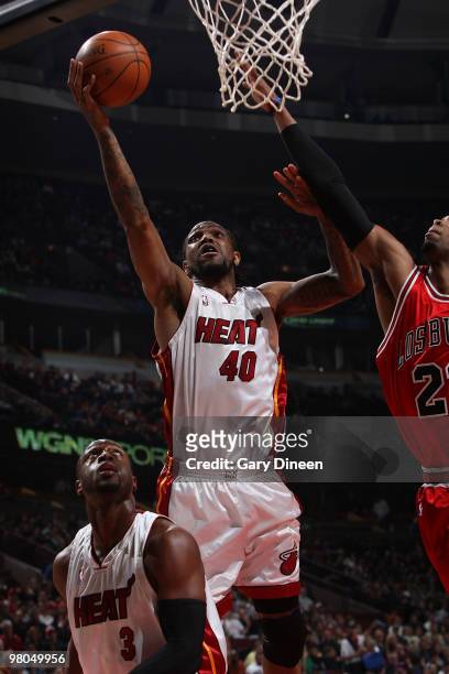 Udonis Haslem of the Miami Heat shoots a layup against Taj Gibson of the Chicago Bulls on March 25, 2010 at the United Center in Chicago, Illinois....
