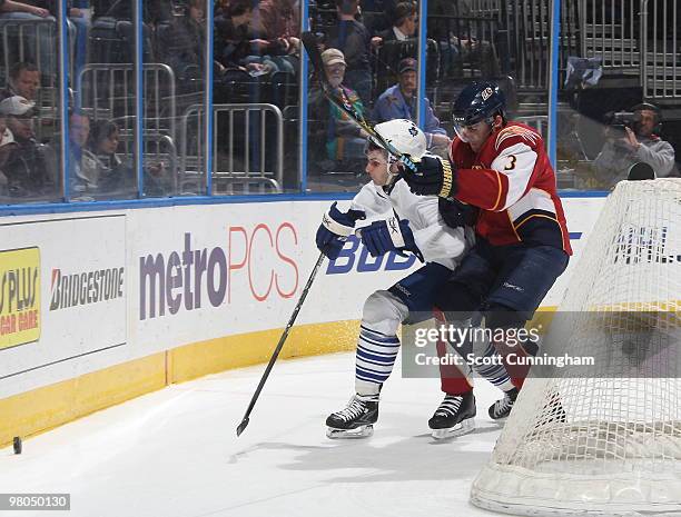 Mark Popovic of the Atlanta Thrashers checks Wayne Primeau of the Toronto Maple Leafs at Philips Arena on March 25, 2010 in Atlanta, Georgia.