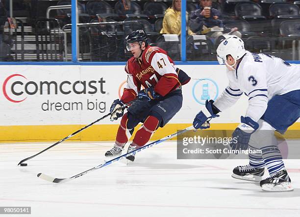 Rich Peverley of the Atlanta Thrashers carries the puck against Dion Phaneuf of the Toronto Maple Leafs at Philips Arena on March 25, 2010 in...