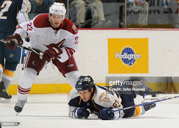 Jordin Tootoo of the Nashville Predators clears the puck against Lee Stempniak of the Phoenix Coyotes on March 25, 2010 at the Bridgestone Arena in...