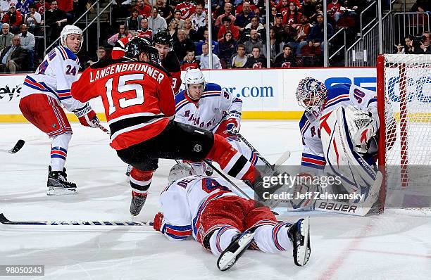 Matt Gilroy, Michael Del Zotto and Henrik Lundqvist of the New York Rangers defend against a shot by Jamie Langenbrunner of the New Jersey Devils at...