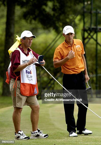 Charles Howell III and his caddy check a putt in final-round play at the FedEx St. Jude Classic May 30, 2004 at the Tournament Players Club...