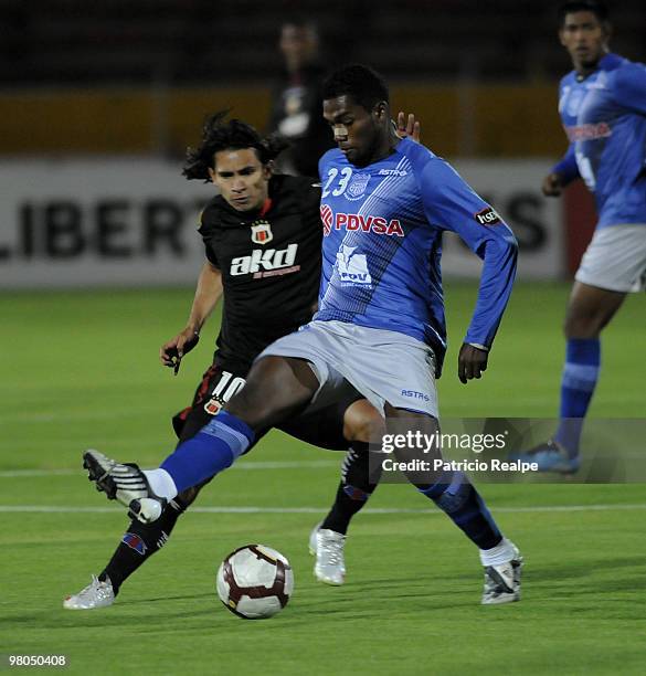 Deportivo Quito's Fernando Saritama vies for the ball with Emelec's Gabriel Achiller during a 2010 Libertadores Cup match at the Atahualpa Stadium on...