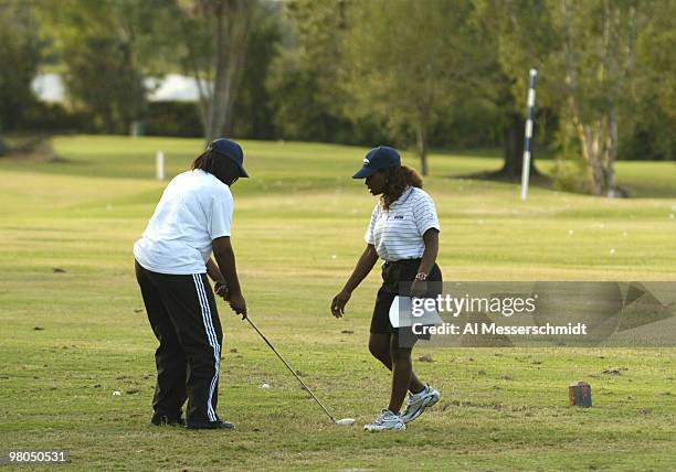 Glf instructor Carla Coonce demonstrates the proper stance to a student participating in the Chrysler Championship Youth Golf Clinic program at...