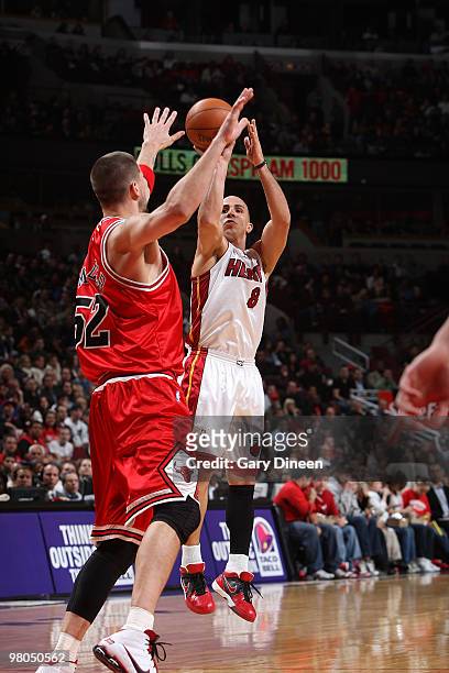 Carlos Arroyo of the Miami Heat shoots a jumpshot against Brad Miller of the Chicago Bulls on March 25, 2010 at the United Center in Chicago,...