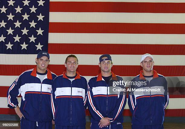 The United States team poses in front of an American flag after the 2004 David Cup semifinal draw ceremony September 23, 2004 aboard the USS Yorktown...