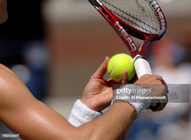 Nathalie Dechy grips a tennis ball before serving to Lindsay Davenport in a women's singles match at the 2005 U. S. Open in Flushing, New York on...