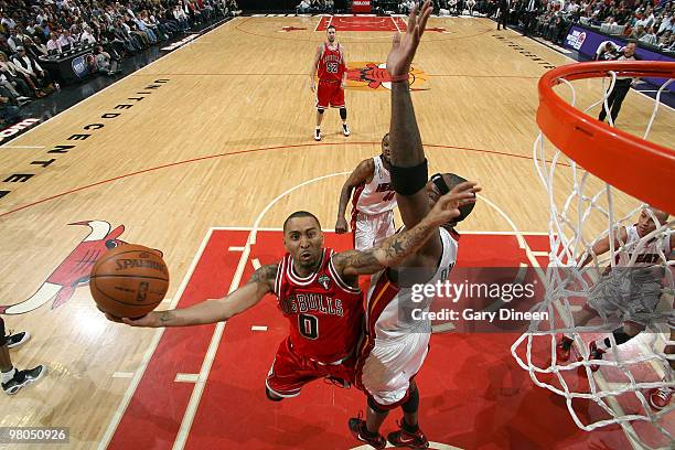 Acie Law of the Chicago Bulls shoots a layup against Jermaine O'Neal of the Miami Heat on March 25, 2010 at the United Center in Chicago, Illinois....