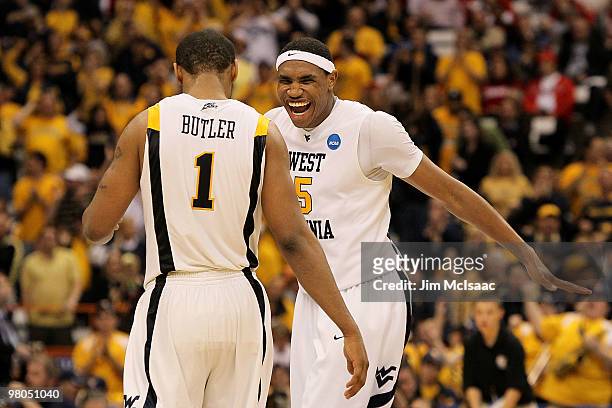 Da'Sean Butler and Kevin Jones of the West Virginia Mountaineers celebrate during the second half against the Washington Huskies during the east...