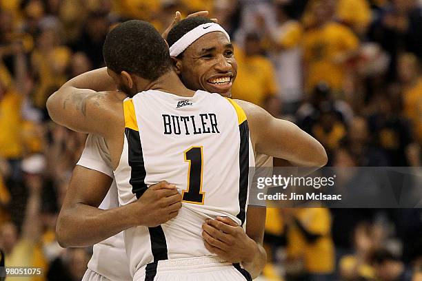 Da'Sean Butler and Kevin Jones of the West Virginia Mountaineers celebrate during the second half against the Washington Huskies during the east...