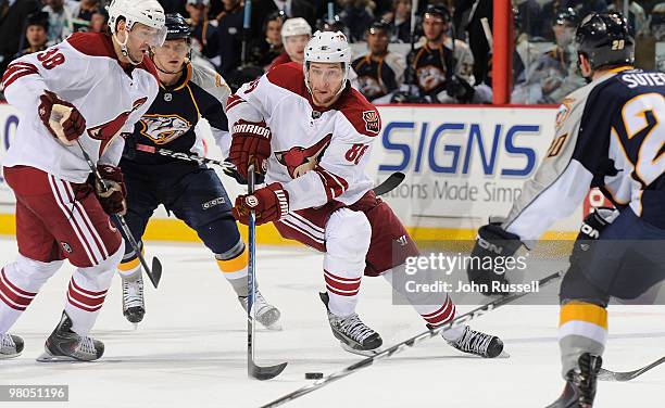 Wojtek Wolski of the Phoenix Coyotes carries the puck into the zone against Ryan Suter and Martin Erat of the Nashville Predators on March 25, 2010...